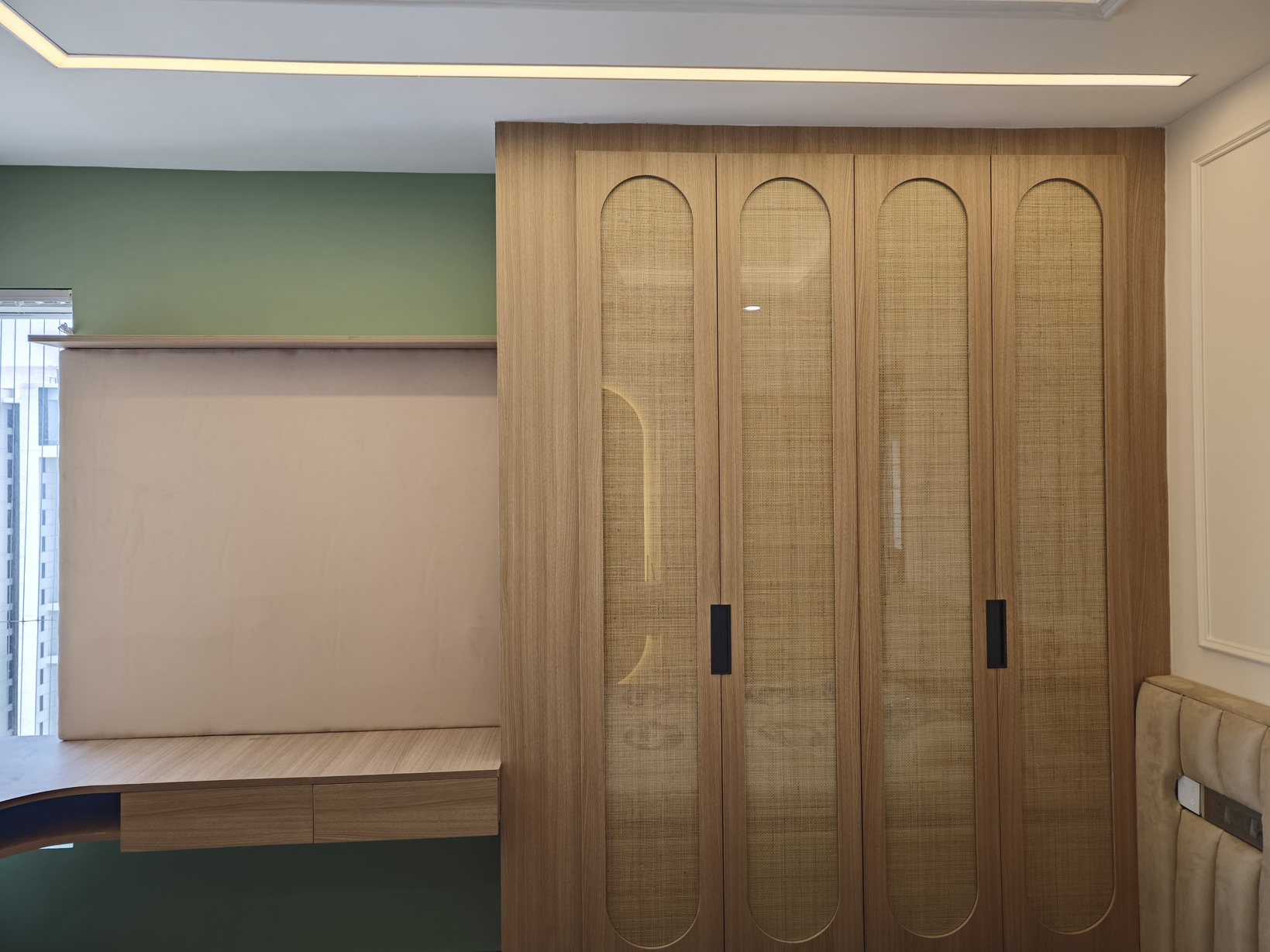 Completed wooden wardrobe with cane-panel doors and a built-in study unit