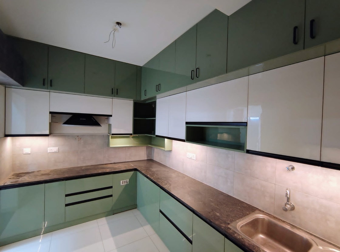 Green modular kitchen from a completed Nestora Lifespaces project